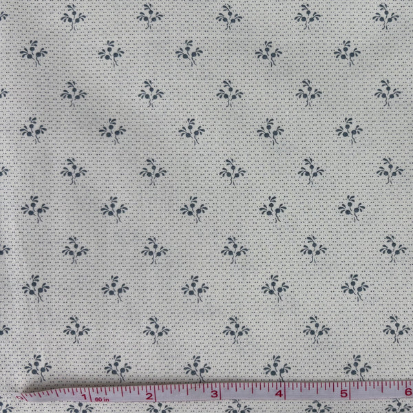 Fabric with a cornflower blue floral design on a off-white background