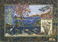 Textile artwork depicting a nature scene with trees, water, and wildlife.