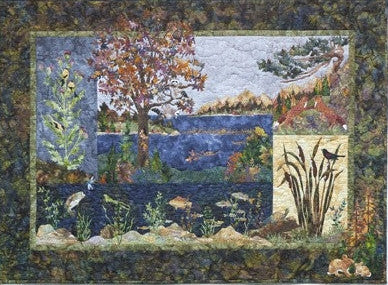 Textile artwork depicting a nature scene with trees, water, and wildlife.
