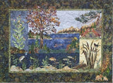 Textile artwork depicting a nature scene with trees, water, and wildlife.